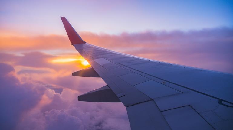 Beautiful sunset, sky on the top view, airplane flying view from inside window aircraft of Traveling.