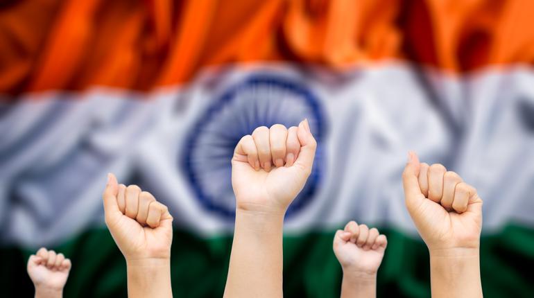 Happy India republic, Hands of people with India national flag in background. Indian Independence Day.