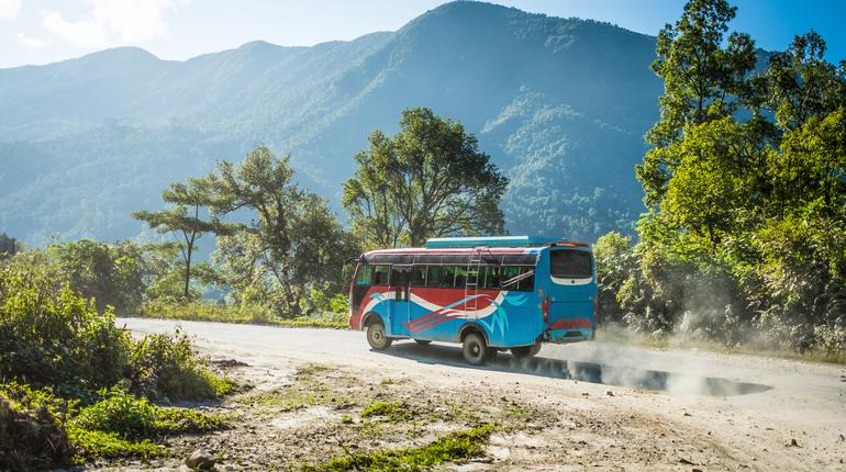 Colourful local bus on mountain road, Annapurna area, Nepal